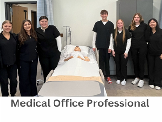 Students in black scrubs pose for a picture by a gurney